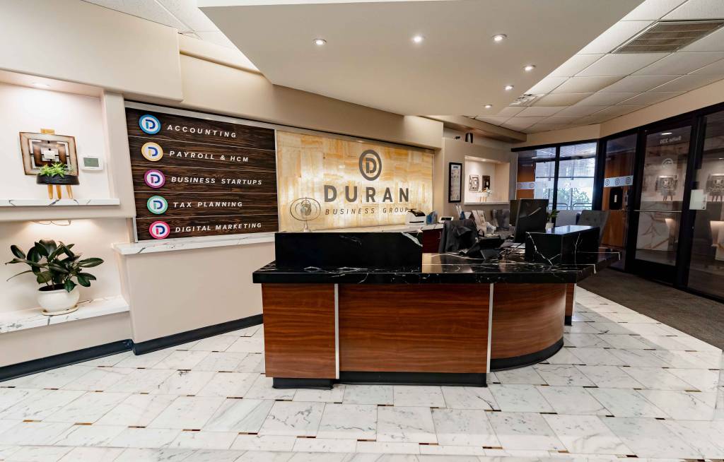 Reception area of Duran Business Group in Phoenix, featuring signage for accounting, payroll, tax preparation, and business consulting services.